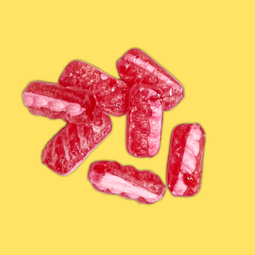 Five pink and white striped gummy candies arranged on a solid yellow background.