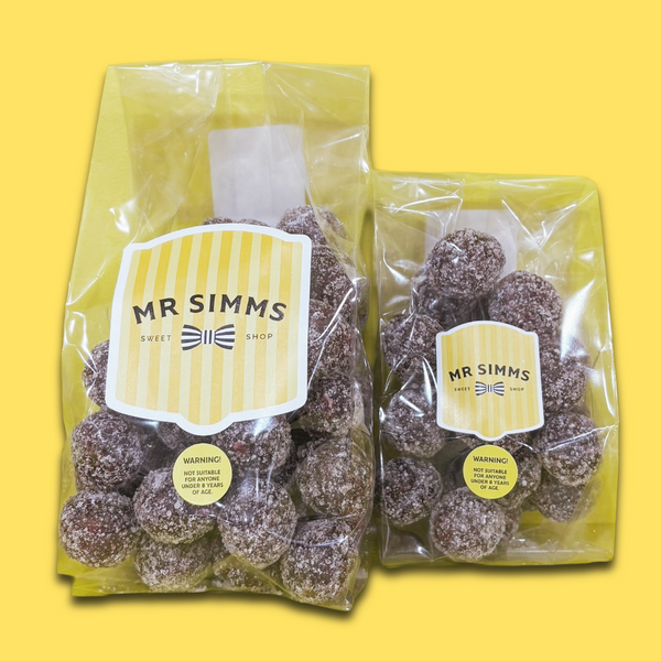Two packages of Mr Simms sweet shop treats on a yellow background