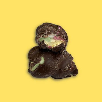 Chocolate-covered treats with colorful centers on a yellow background