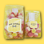 Two packages of sour candies with 'Mr Simms Sweet Shop' label on a yellow background