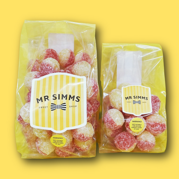 Two packages of sour candies with 'Mr Simms Sweet Shop' label on a yellow background