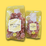 Two packages of Mr Simms gummy bears on a yellow background