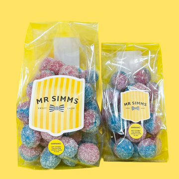 Two packages of colorful gummy bears with 'MR SIMMS' labels on a yellow background