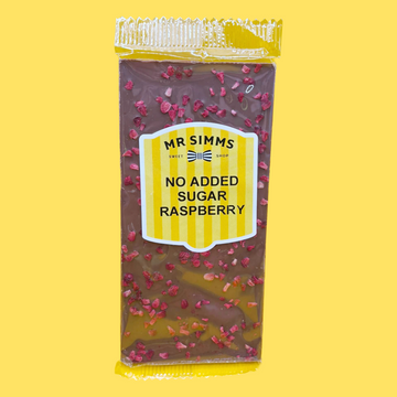 Packaged chocolate bar with raspberry pieces on a yellow background