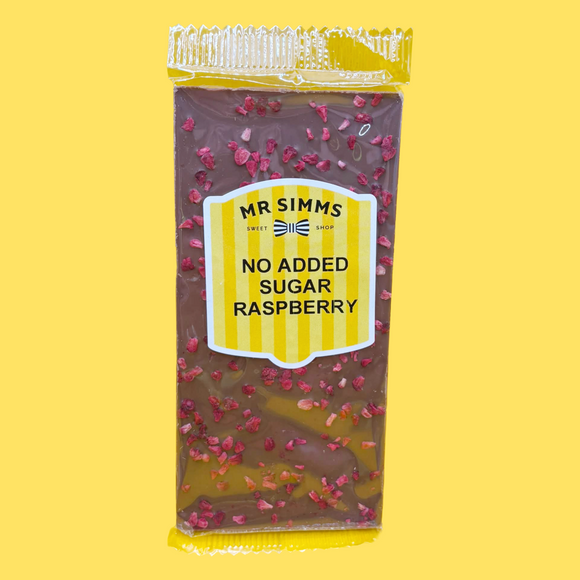 Packaged chocolate bar with raspberry pieces on a yellow background