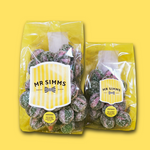 Two packages of Mr Simms sweets on a yellow background