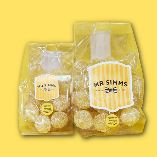 Two packages of Mr Simms sour sweets on a yellow background