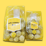 Two packages of Mr Simms gummy bears on a yellow background
